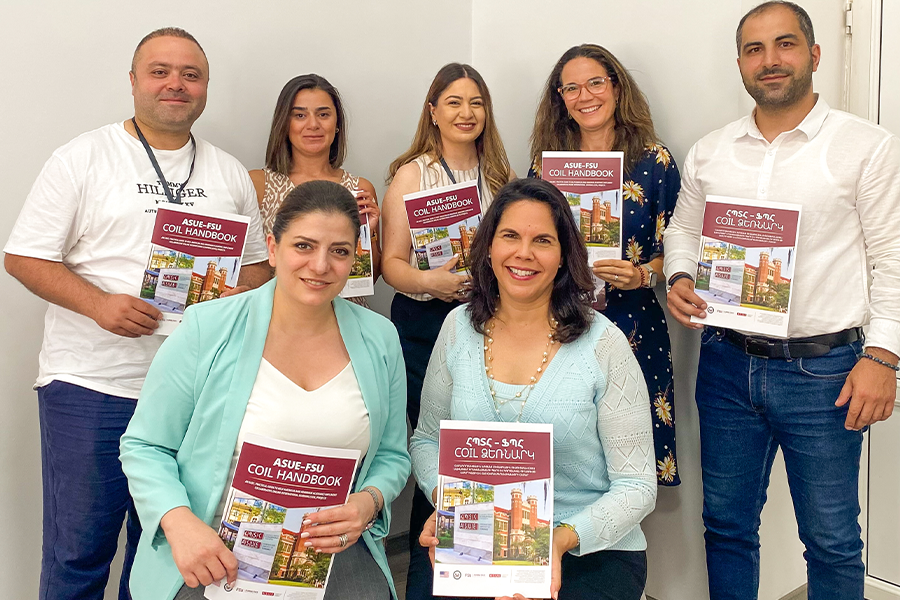 Vilma Fuentes posing with a group all holding up the same book