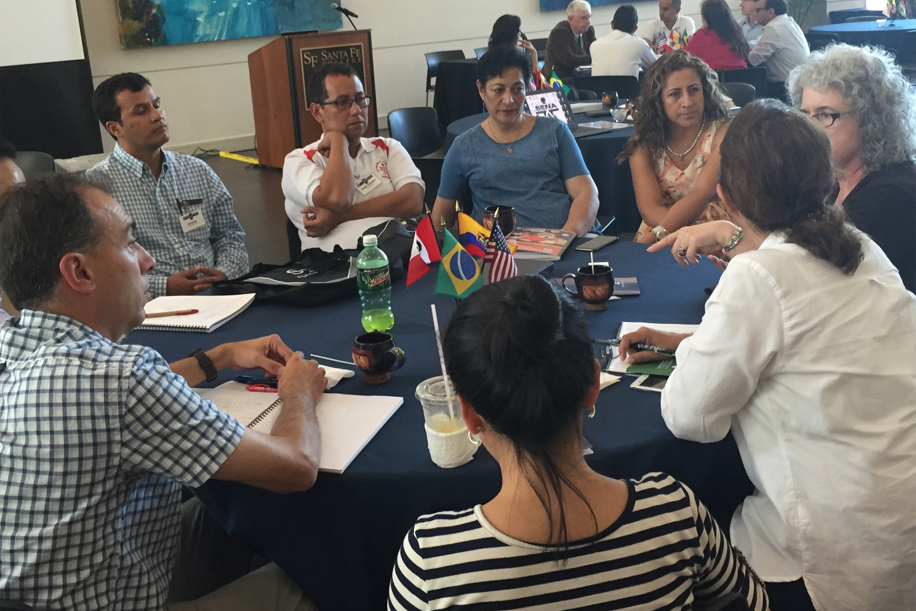 "Group of people around a table with inside Santa Fe College"