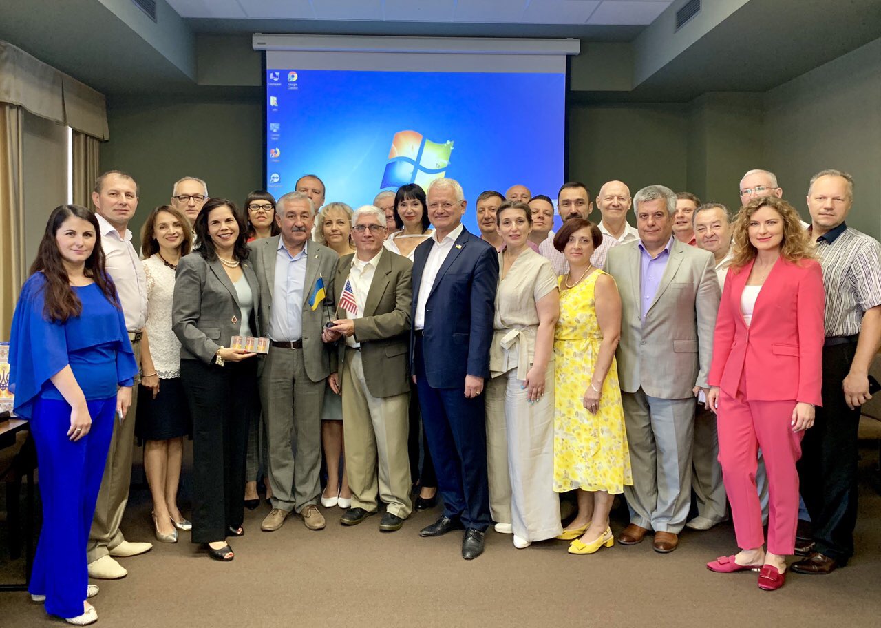 "Ukraine CCAP group posing inside a classroom in front of a projection screen"