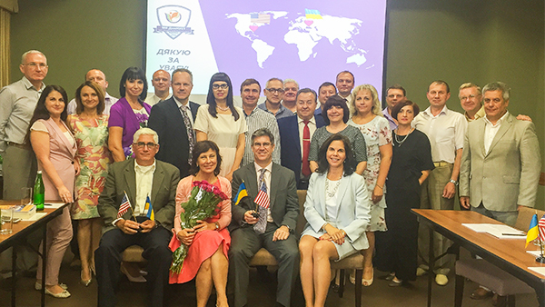 "Dr. Fuentes and Dr. Milligan pose for a group photo on a visit to Ukraine in 2018."