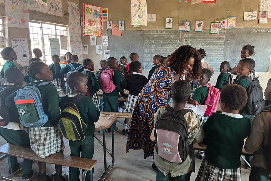 Teacher in a classroom in Zambia interacting with students.
