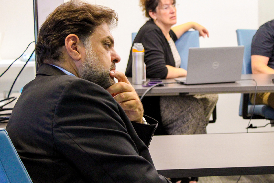 "Close up photo of Rabieh Razzouk listening to someone speaking"