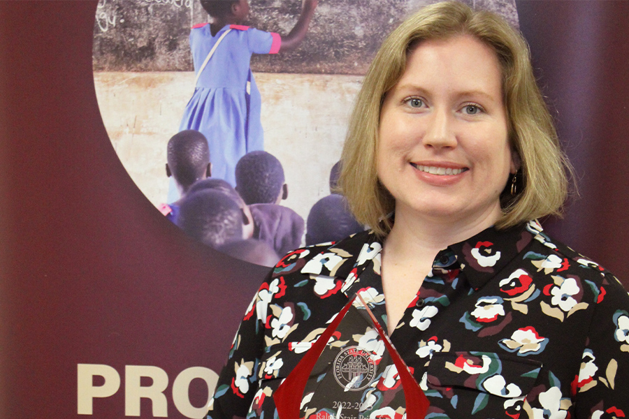 "Dr. Stephanie Zuilkowski poses with the Ralph Stair Prize"