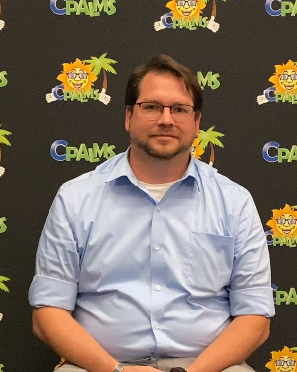 Photo of a teacher seated in front of a CPALMS back drop conducting an interview