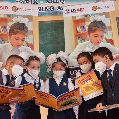 Group of young students in Uzbekistan reading books written in English