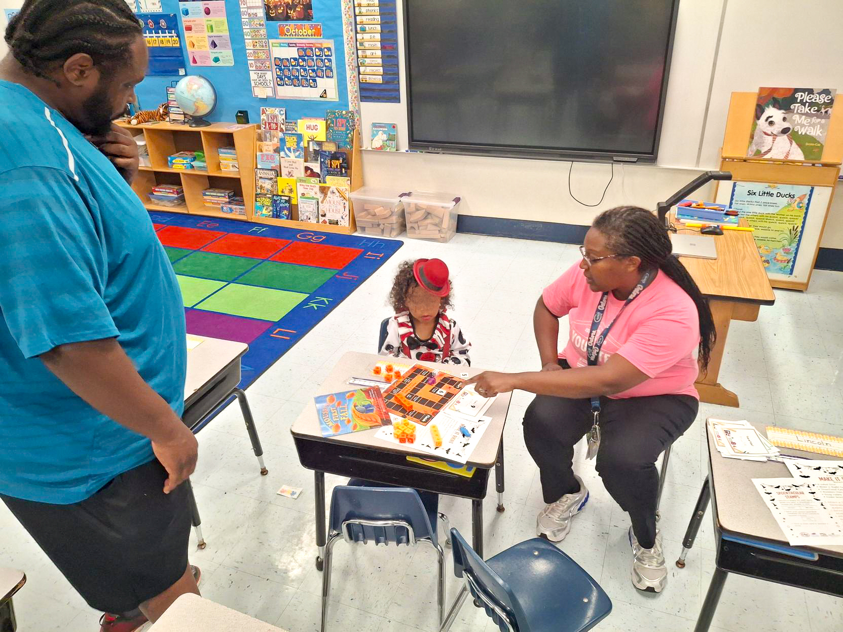 Young student in a classroom working with an educator.