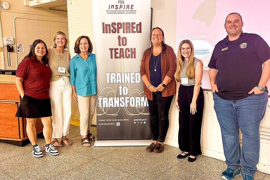 Group photo of six people in front on an FSU InSPIRE stand-up banner. 