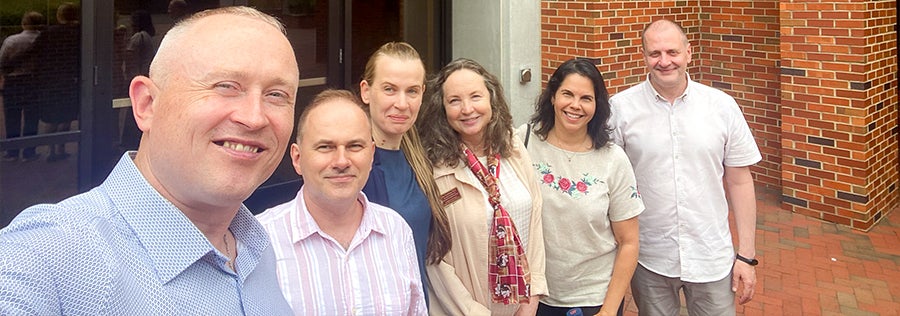 Group photo with Dr. Dina Vyortkina and BridgeUSA participants in front of Anne's College on the FSU campus. 