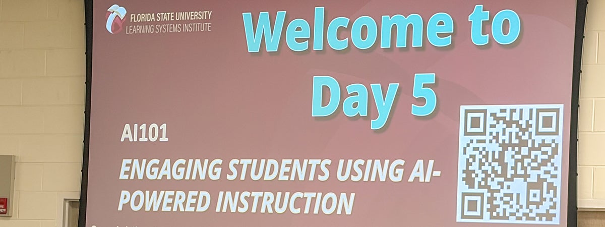 Large projection screen with information about Day 5 of the InSPIRE AI 101 workshop.