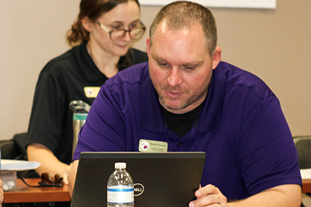Photo of LSI STEM Specialist/Assistant in Research Robert Hanna working at a laptop.