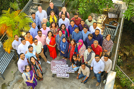 Group photo taken from above of a group in Bangladesh posing for a photo.