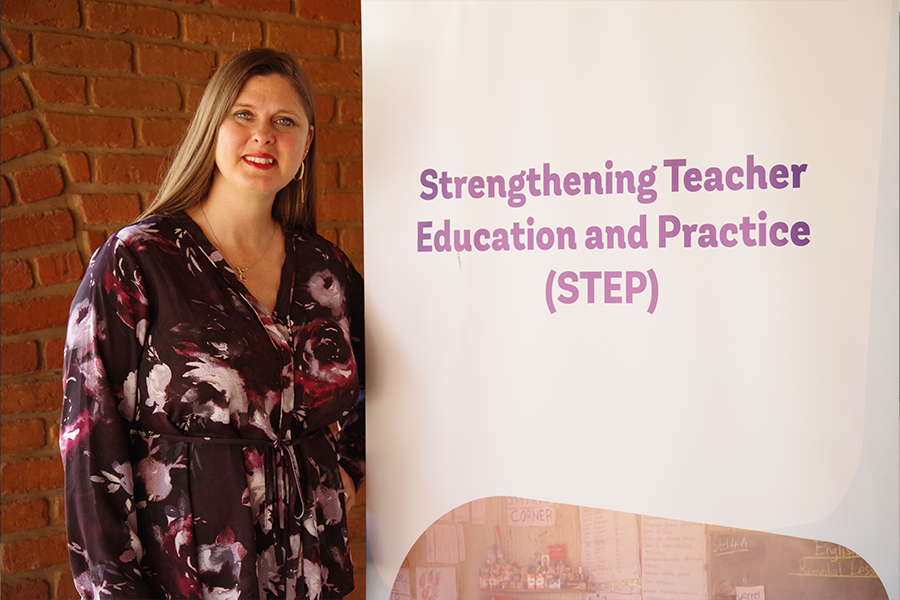 Adrienne Barnes-Story posing in front of a banner for the STEP Project.