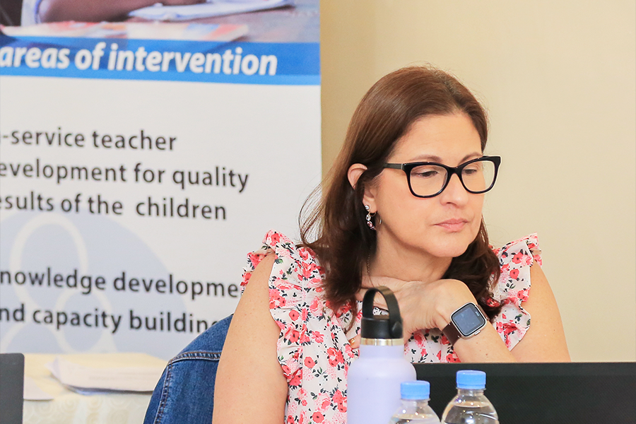 Ana H. Marty at a workshop sitting behind a laptop