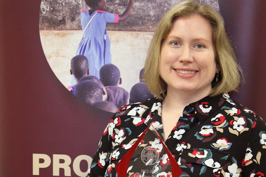 Stephanie Simmons Zuilkowski posing with the Ralph Stair Prize