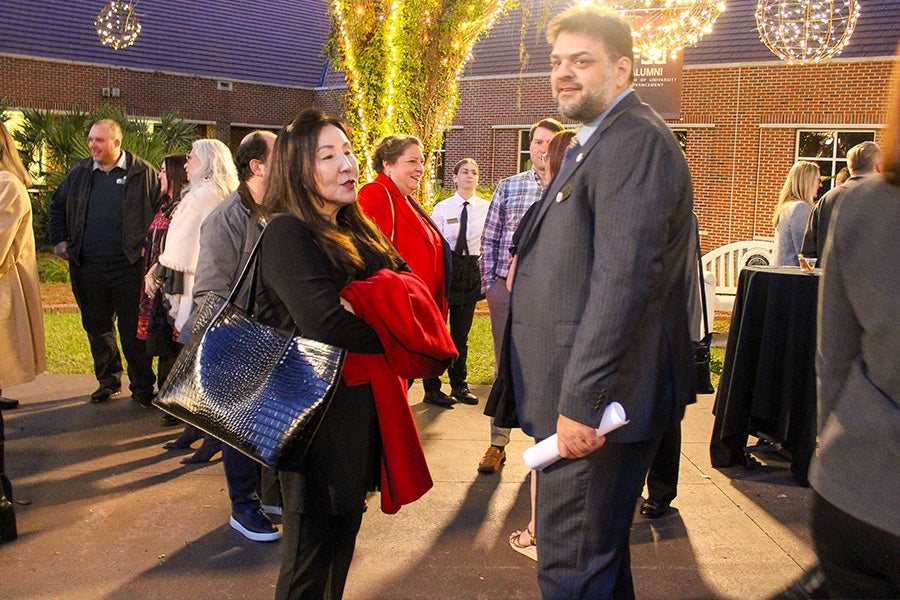 Rabieh Razzouk at the LSI annual banquet talking with a woman outdoors.