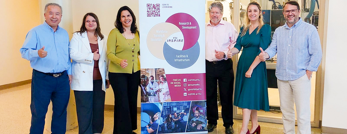 Group of six people posing in front of a banner for FSU InSPIRE.