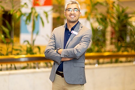 Bhushan Dahal posing at Educators Shaping Futures conference. 