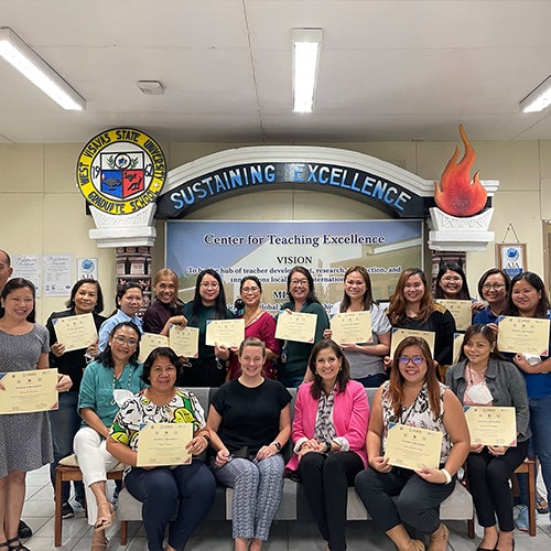 "Group photo of educators in the Philippines holding certificates"