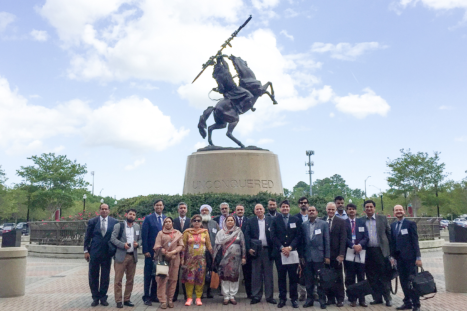 "CCAP Pakistan group posing in front of the Unconquered Statue at FSU"