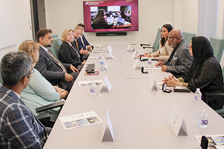 "President of the United Nations General Assembly, Mr. Dennis Francis sitting at a conference table in a meeting with LSI staff."