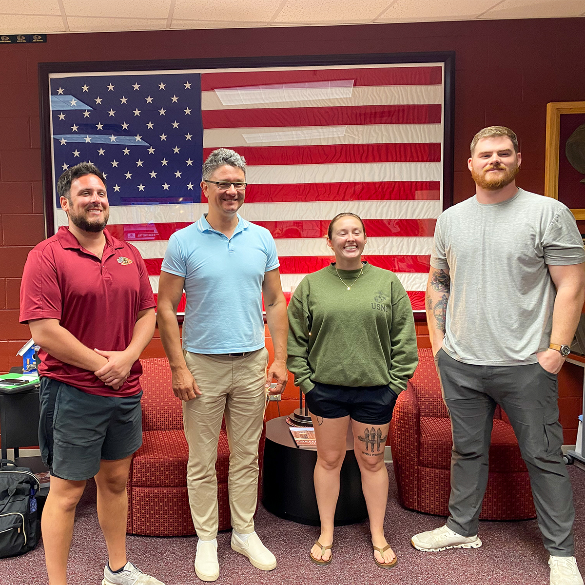 Dr. Dmytro Stepanskyi at the FSU Veteran's Center posing for a photo with three others.