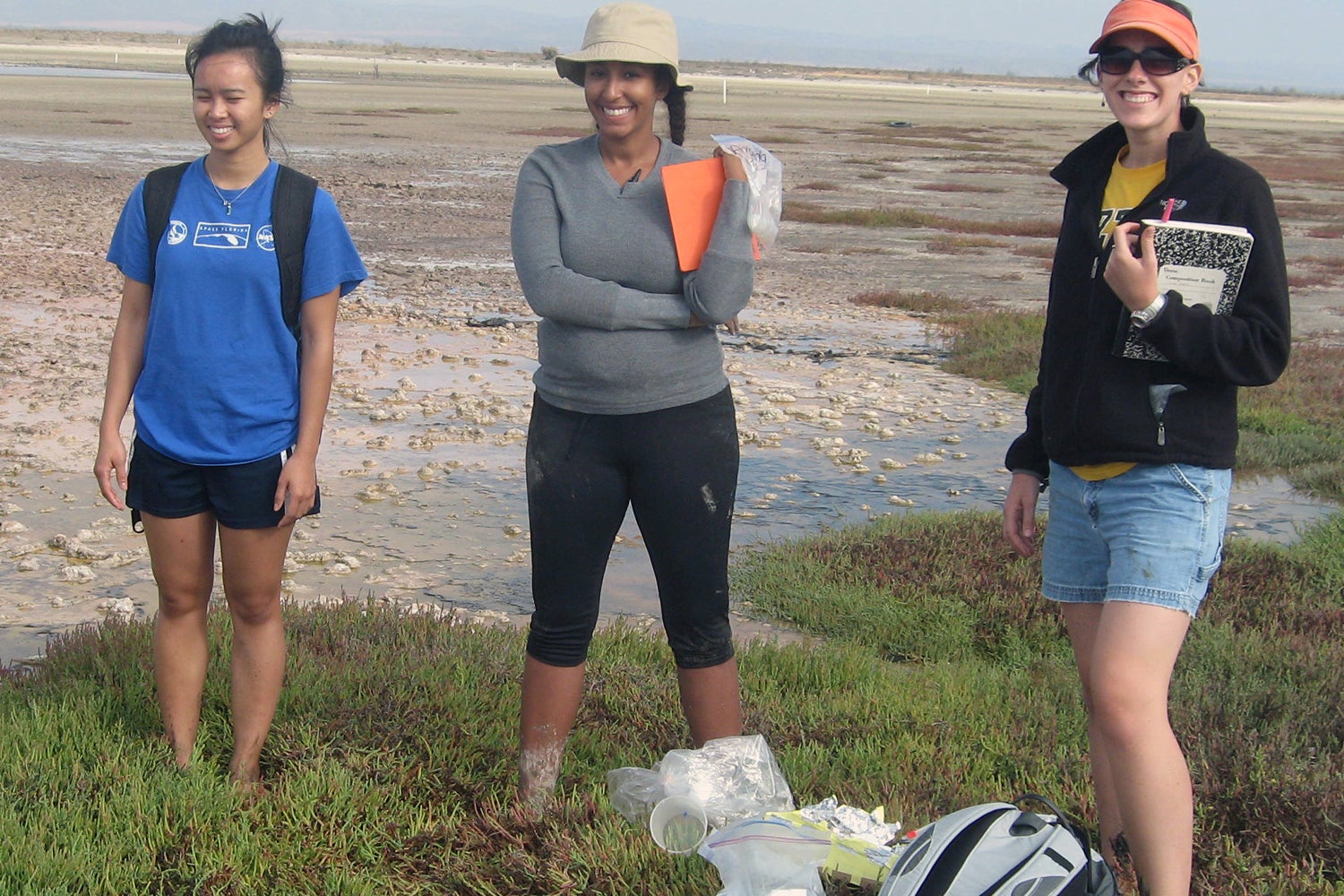 "Dr Tazaz and two colleagues standing in an outdoor area near water"