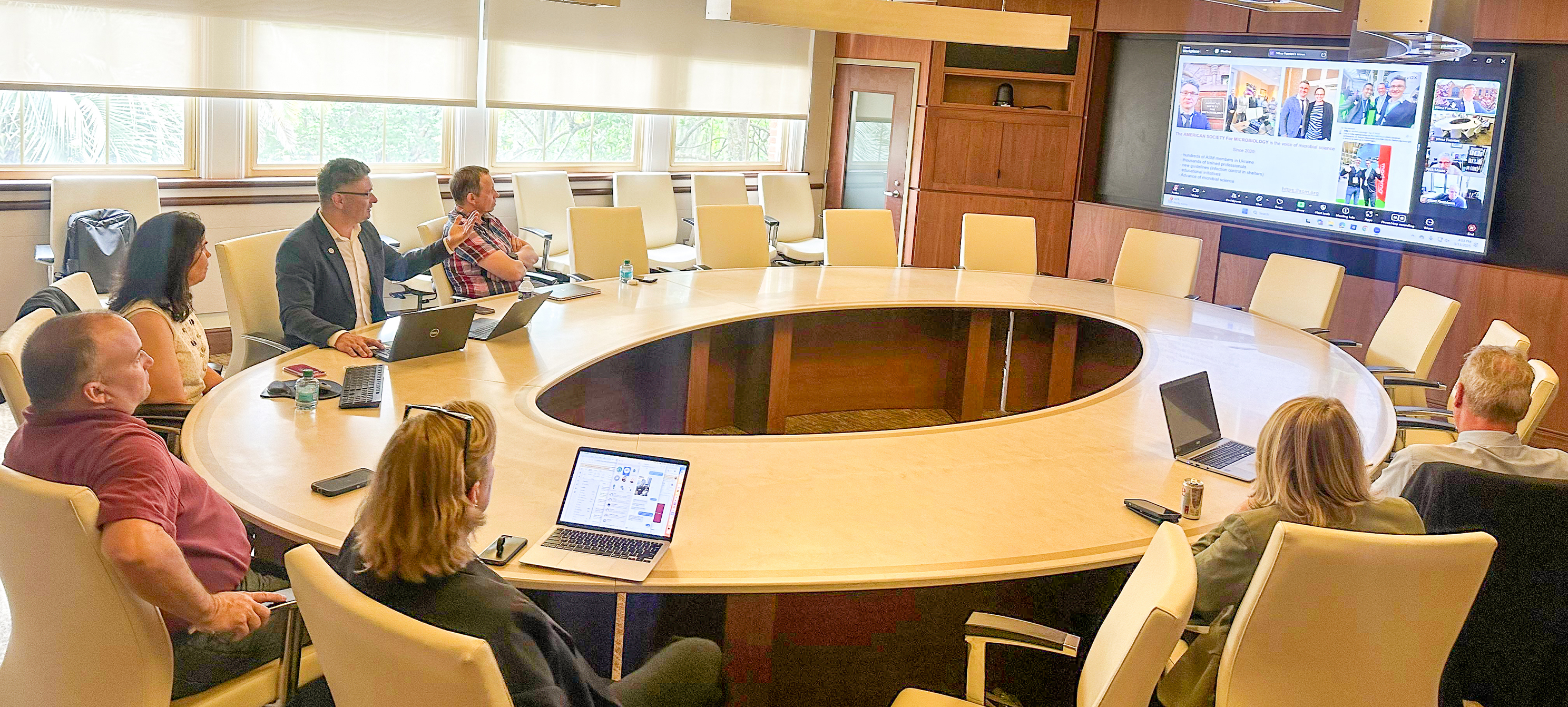 Dr. Stepanskyi sitting at a large round conference table during a meeting.