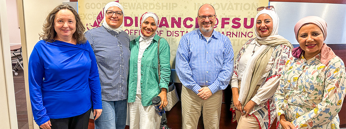 "Egyptian fellows posing for a photo with two FSU employees in the Office of Distance Learning."