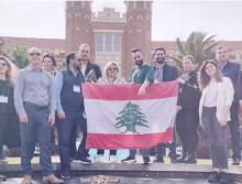 Visiting educators from Lebanon holding a Lebanese flag in front of Florida State's Westcott building. 