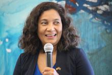 Woman smiling with a microphone in hand