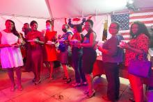 People at a dinner event holding food and drinks
