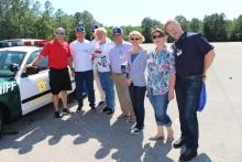 CCAP Ukraine participants posing next to an Alachua County sheriff's car