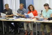 Members of the CCAP Ukraine group sitting at a classroom table looking at handouts
