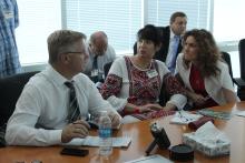 Three people in a discussion sitting at a table