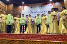 A group on stage during a welcome ceremony