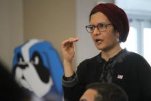 A woman speaking and making a hand gesture