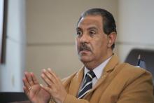 A man speaking and making hand gestures