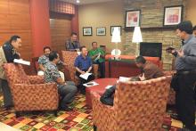 Group of men gathered in a communal area. 