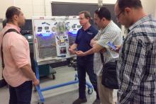 A small group in a classroom listening to a presentation
