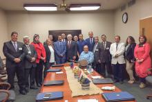Group photo of members of the CCAP Egypt group around a table in a conference room