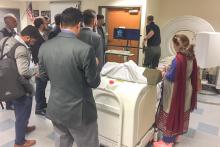 CCAP Pakistan listening to a presentation in a room with medical devices