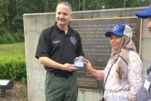 The director of the Santa Fe College Institute of Public Safety presenting a small gift to one of the CCAP members 