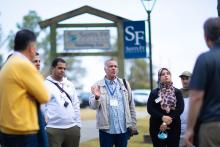 Group standing outside having a discussiojn