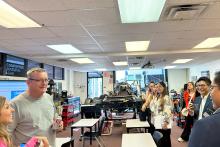CCAP Mexico members in a Lively Technical College classroom with a large truck engine and tires in the background 