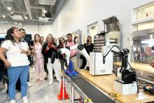 CCAP Mexico group members observing a robotic arm working