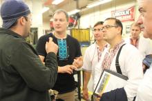 Group of men in discussion inside a vocational classroom