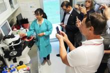 Group of people standing listening to a presenter