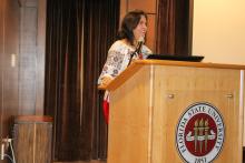 Dr. Vilma Fuentes at the podium addressing the crowd.