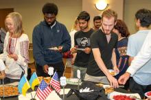 Guests eating appetizers at the Globe Vyshyvanka Day celebration.