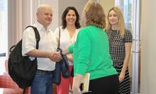 Dr. Adrii Paziuk meets Michelle Kazmer, dean of the College of Communication and Information. Dr. Vilma Fuentes and Anna Romanova are with him.